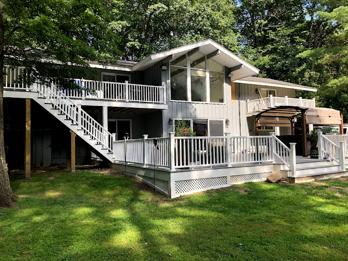 A large white house with a large deck