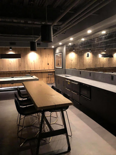 A kitchen with a table and stools in it