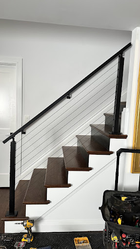 A suitcase sitting on the ground next to a stair case