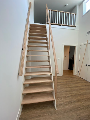 A staircase leading to a second floor bedroom